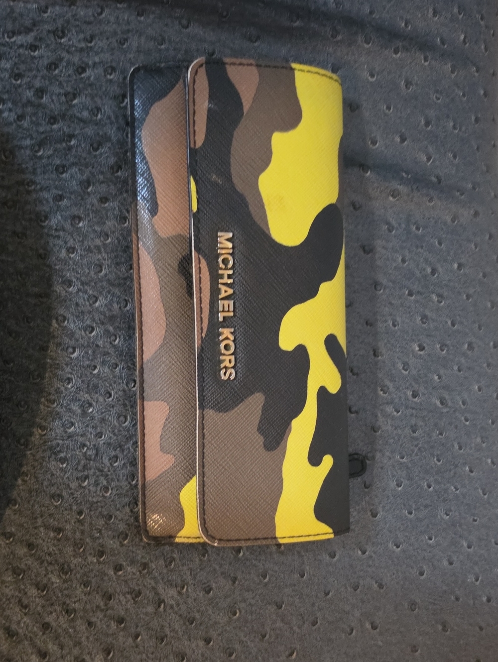 Michael Kors Jet Set Travel slim wallet featuring an acid yellow and black.